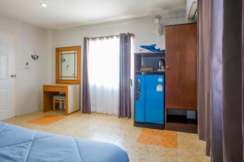 a room with a blue refrigerator and a desk at Klong Muang Sunset House in Klong Muang Beach