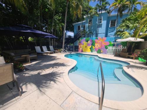 a swimming pool in front of a building at Duval Street Suite with pool in Key West