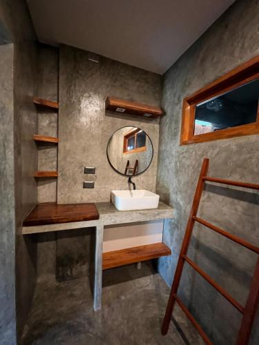 a bathroom with a sink and a mirror at Chief Mau Moalboal Cebu in Moalboal