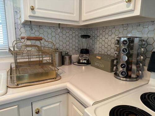 a kitchen with a counter top with a appliance at The Mirror Lake Suite in Fayetteville