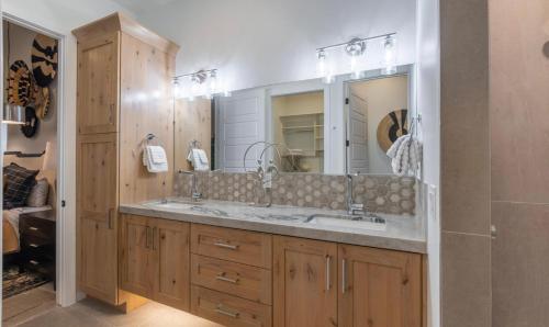 a bathroom with a sink and a large mirror at Paradise Retreat at Copper Rock! in Hurricane