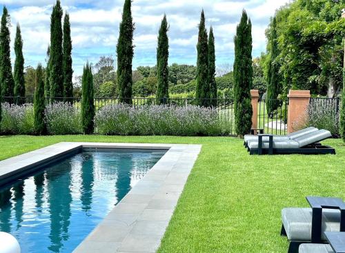 a swimming pool in the middle of a yard at Frogs Pond in Red Hill