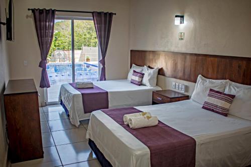 Postel nebo postele na pokoji v ubytování hotel isla Bonita