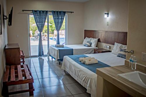 Postel nebo postele na pokoji v ubytování hotel isla Bonita