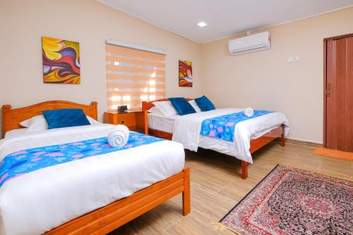 a bedroom with two beds and a rug at PULANG RESORT in Setiu