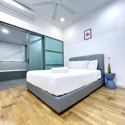 a bedroom with a large bed and glass walls at Iskandar Residences 2BR 5pax 5 mins Legoland Wi-Fi Sky Pool 360 in Nusajaya