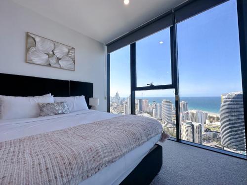 a bedroom with a bed with a view of the ocean at Oceanview Paradise 2Beds Apt at Casino FreeParking in Gold Coast