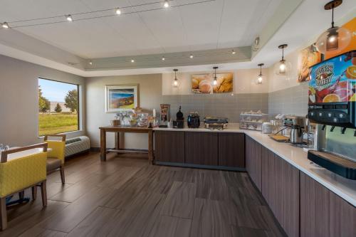 a large kitchen with a counter and a table at Comfort Inn & Suites Tipp City Dayton North I-75 in Tipp City