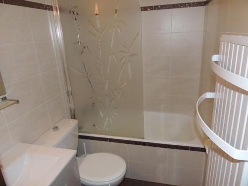 a white bathroom with a toilet and a shower at Studio Châtel, 1 pièce, 4 personnes - FR-1-676-98 in Châtel