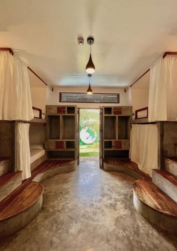 an empty room with wooden floors and a large window at Chief Mau Moalboal Cebu in Moalboal