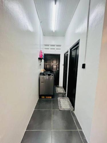 a hallway with a small refrigerator in a room at Homestay CikPuteh Gunong, Bachok in Bachok