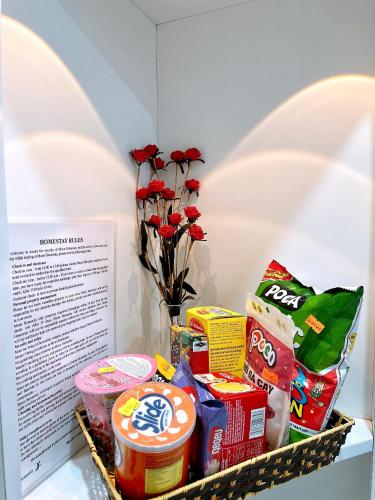 a basket filled with food and a vase of flowers at Moon Homestay in Thôn Kim Long (1)