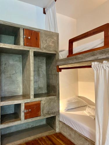 a bedroom with bunk beds in a hostel at Chief Mau Moalboal Cebu in Moalboal