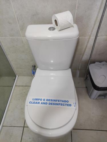 a bathroom with a toilet with a sign on it at Encanto da Praia hotel pousada in Natal