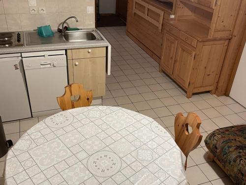 - une cuisine avec une table et un évier dans l'établissement Appartement cosy 3 pièces pour 6 pers., proche télécabine Linga, balcon, garage, animaux admis - FR-1-676-158, à Châtel