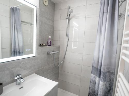 une salle de bain avec une douche, un lavabo et un miroir dans l'établissement Studio confortable à Châtel – 4 pers, balcon, expo S/O, proche du centre - FR-1-676-168, à Châtel