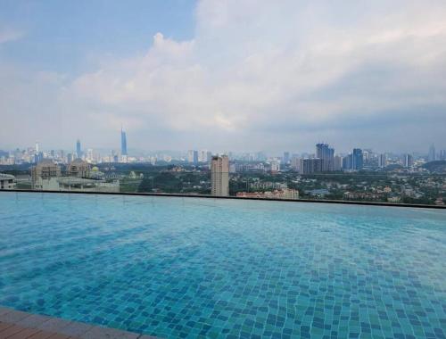 a large swimming pool with a view of a city at Ooak Residence in Mont Kiara, Kuala Lumpur in Kuala Lumpur