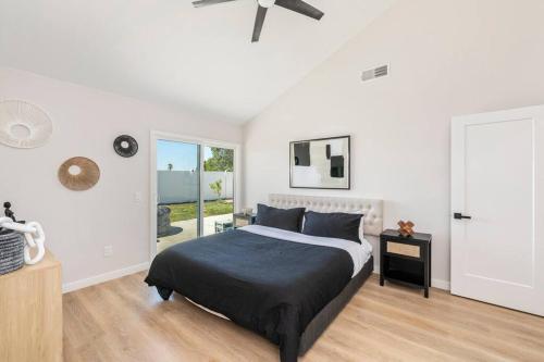 a bedroom with a bed and a ceiling fan at Vineyard Chic Oasis: Modern Elegance near Temecula Wineries in Temecula