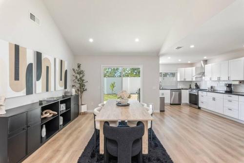 a kitchen with a table and a dining room at Vineyard Chic Oasis: Modern Elegance near Temecula Wineries in Temecula