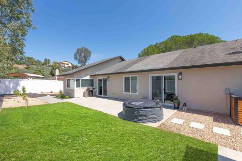 a house with a green lawn in front of it at Vineyard Chic Oasis: Modern Elegance near Temecula Wineries in Temecula