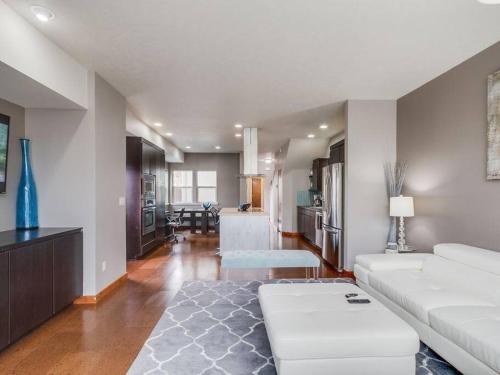 a living room with a white couch and a kitchen at Brand New Downtown Modern 5 Beds, 3 Full Baths Vermont Avenue, Boise in Boise