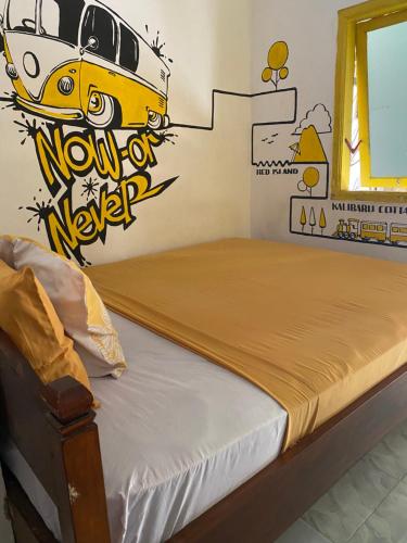 a bedroom with a bed with a painting of a car on the wall at Banana Homestay in Banyuwangi