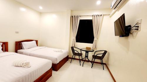 Postel nebo postele na pokoji v ubytování Chotika Hotel โรงแรมโชติกา ณ เชียงคาน