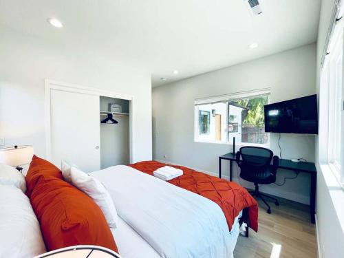 a bedroom with a bed and a desk and a television at Sunnyvale Cozy New 3B3b home/Gogle/speed WiFi in Sunnyvale