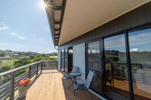 a balcony of a house with a table and chairs at Sunset Meadows in Sunset Strip