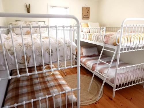 a bedroom with two bunk beds and a crib at Sunset Meadows in Sunset Strip