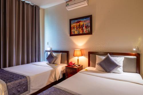 Postel nebo postele na pokoji v ubytování Baly Hotel Hue
