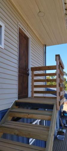 a wooden porch with a wooden door on a house at Lily Home in Algarrobo