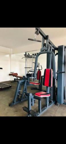 a gym with two chairs and a treadmill at One bed airbnb with pool by Omuts in Kiambu