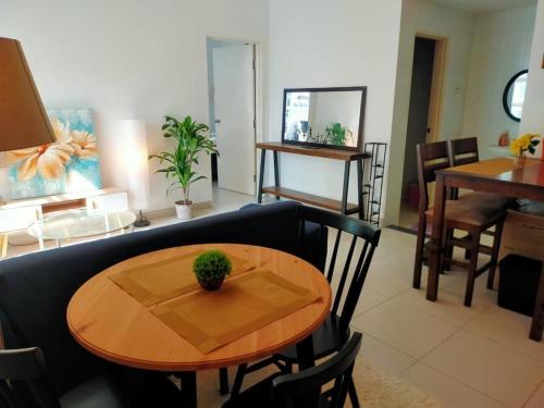 a living room with a table and a couch at Reen's Cosy Place in Cyberjaya