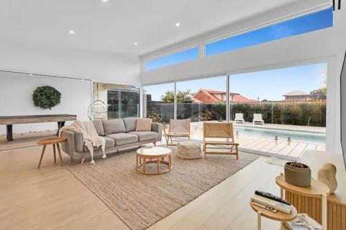 a living room with a couch and a table at The Family Beachside Escape by Ready Set Stay - HOUSE in Rosebud