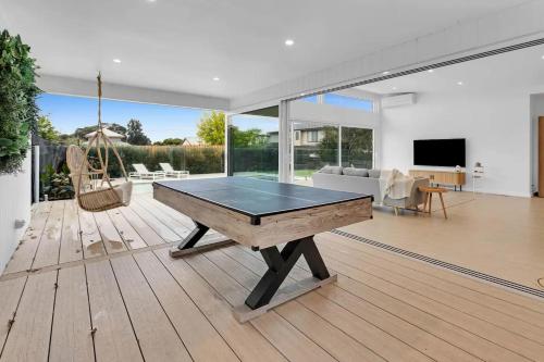 a ping pong table in a living room at The Family Beachside Escape by Ready Set Stay - HOUSE in Rosebud