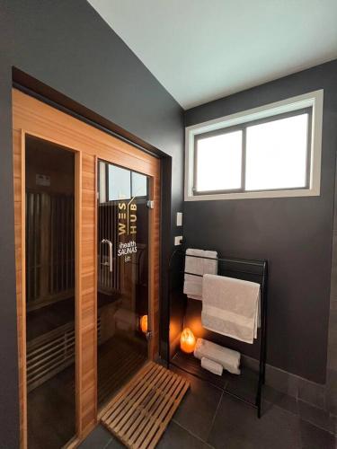 a bathroom with a walk in shower with a window at WEST HUB. Private Infrared Sauna near city & much more! New purpose built loft style! in Brisbane