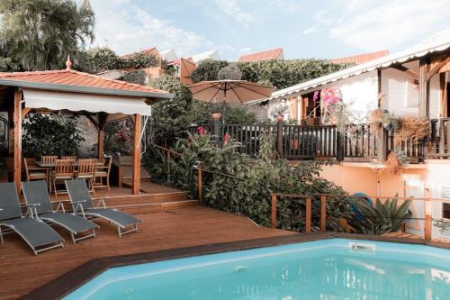 une maison avec une piscine et une terrasse dans l'établissement Villa T4 - Bleu Mer Caraïbes, à Case-Pilote