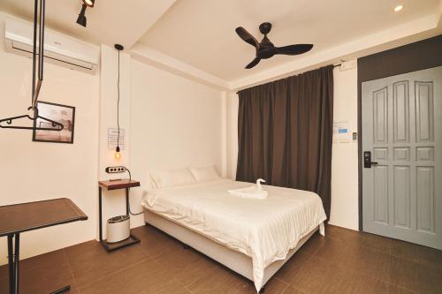 1 dormitorio con 1 cama y ventilador de techo en Hotel Gray in Boracay en Boracay