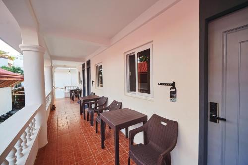 a row of tables and chairs on a balcony at Hotel Gray in Boracay in Boracay