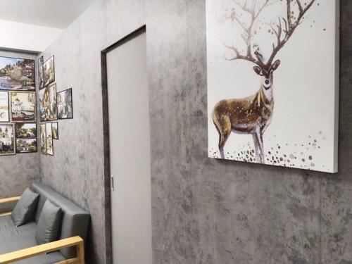 a painting of a deer on a wall at C226 Place at SMDC Cheer Residences by Lee Portum in Marilao