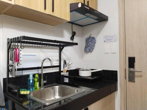 a kitchen with a sink and a counter top at C226 Place at SMDC Cheer Residences by Lee Portum in Marilao