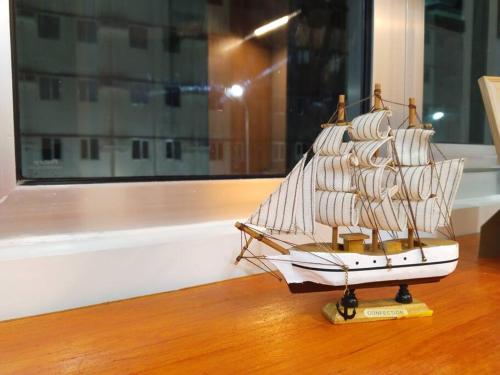 a model of a ship on a wooden table at C226 Place at SMDC Cheer Residences by Lee Portum in Marilao