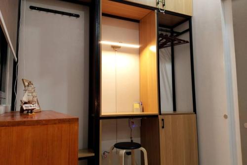a room with a kitchen with a mirror and a cabinet at C226 Place at SMDC Cheer Residences by Lee Portum in Marilao