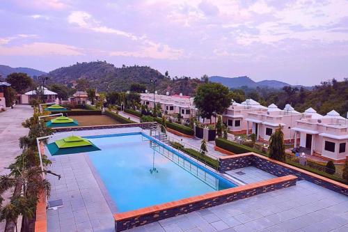 an overhead view of a swimming pool at a resort at The Sky Imperial Nakoda Green Valley Resort in Nāthdwāra