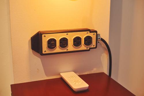 a speaker on top of a table with a remote control at Hotel Gray in Boracay in Boracay