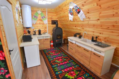a kitchen with a stove and a sink in a room at A frame Sima in Breb