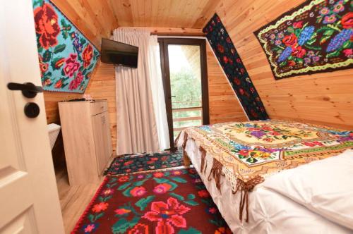 a bedroom with a bed in a wooden room at A frame Sima in Breb