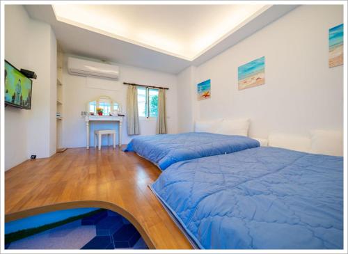 Una cama o camas en una habitación de My Ocean Villa 月牙桐海景民宿
