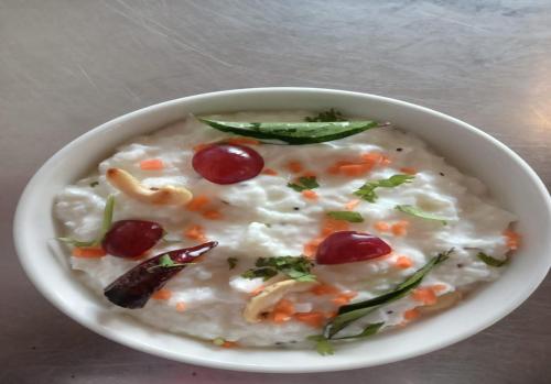 a bowl of oatmeal with cherries and other vegetables at Teanest by Nature Resorts and Stays in Coonoor